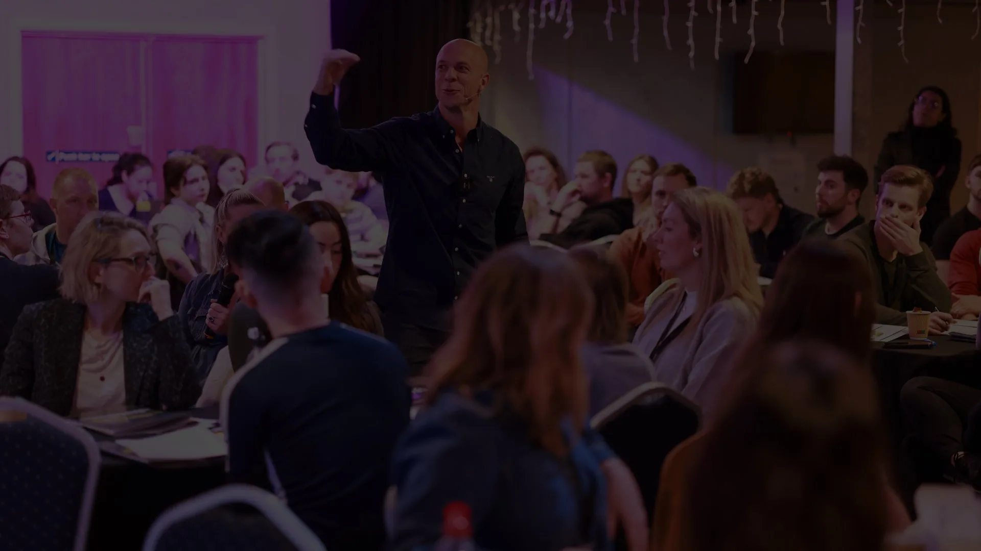 Ryan speaking on stage at a business mastermind